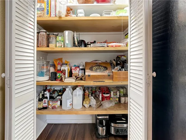 a shelf with cup and plates
