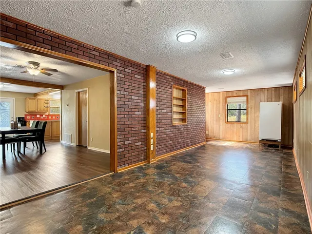 an empty room with wooden floor and furniture