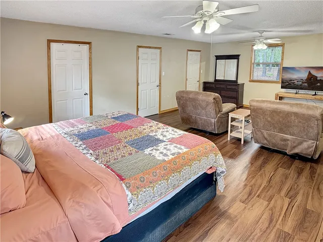 a bedroom with two beds and a chandelier