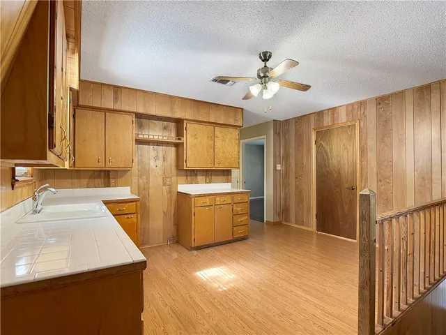 a kitchen with a sink appliances and cabinets
