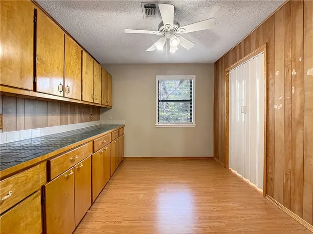 a view of a kitchen with microwave and cabinets
