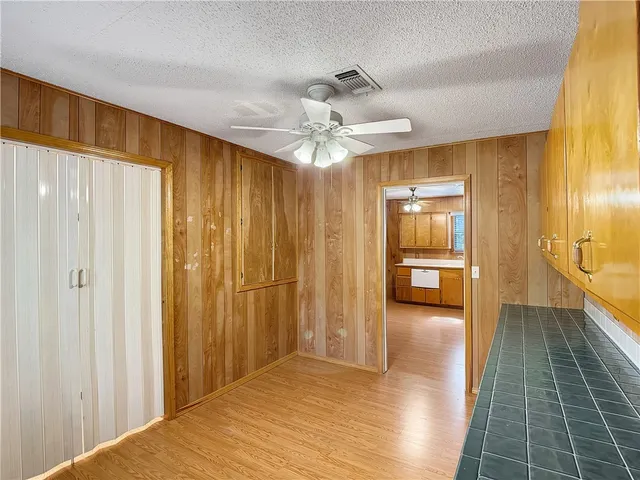 a bedroom with a bed chandelier and a window