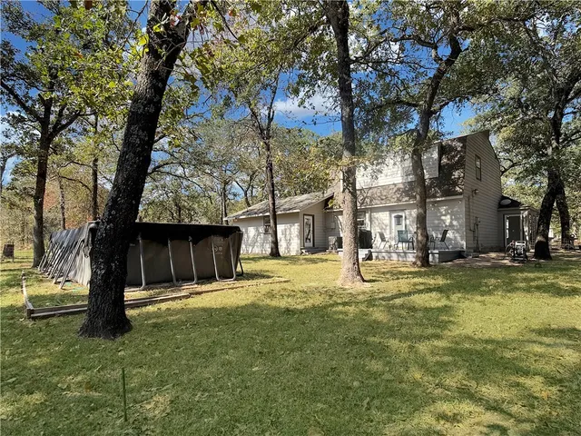 a view of swimming pool with a tree in the background
