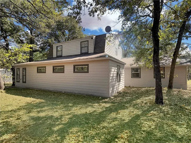 a view of a backyard with large tree
