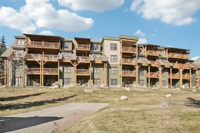 a view of a building with snow on the road