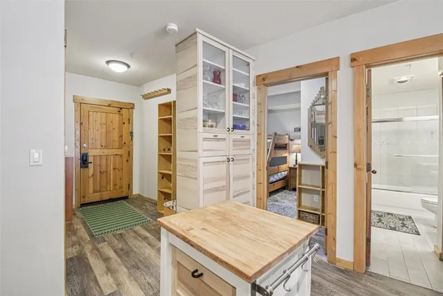 a view of kitchen island with cabinets and wooden floor