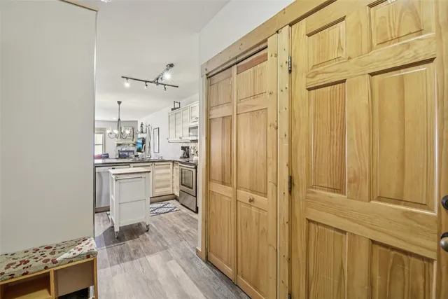 a kitchen with white cabinets and sink