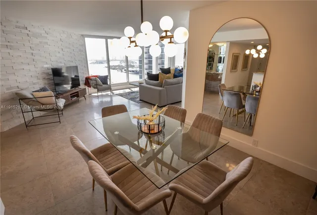a view of a dining room with furniture and a chandelier
