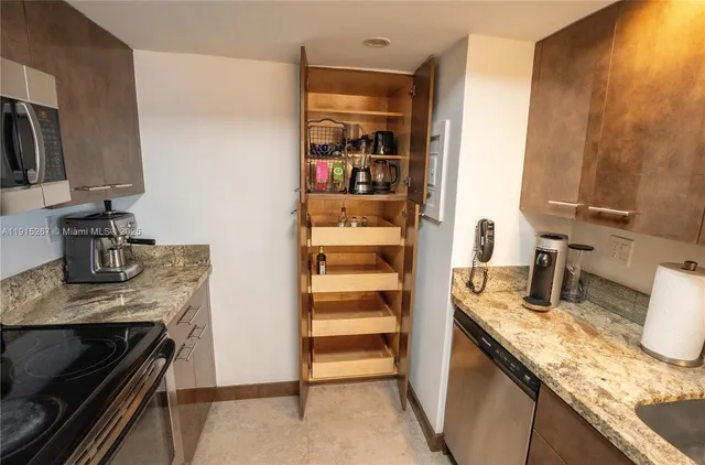 a kitchen with a sink and a stove top oven