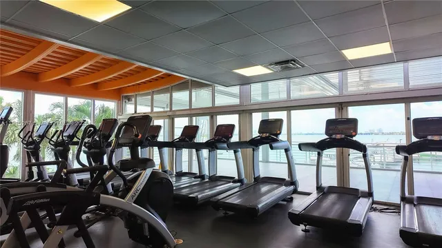 a room with gym equipment and a large window