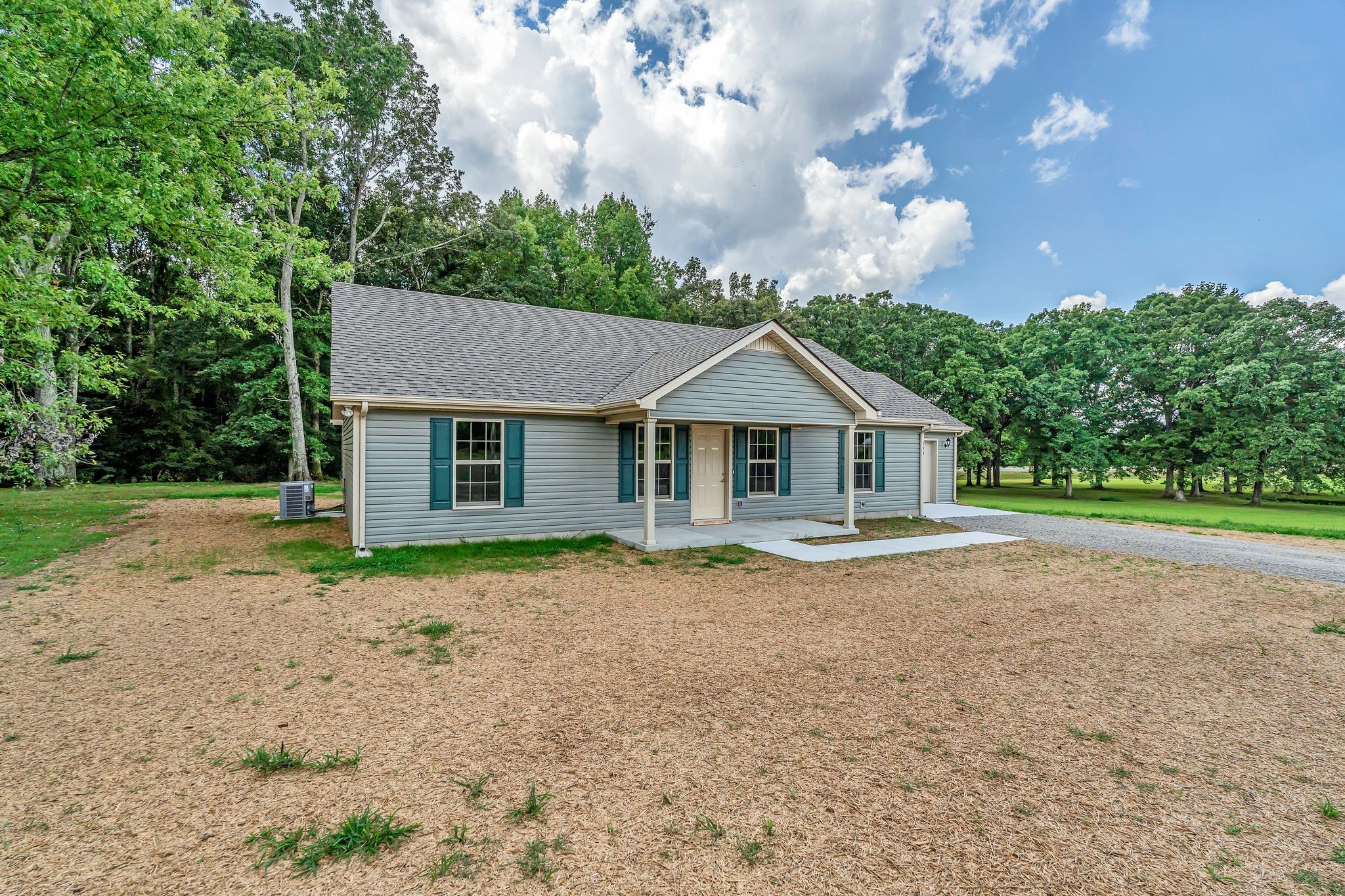 393 Flowertown Road Normandy, TN 37360 - Photo 2 of 34 a front view of a house with garden