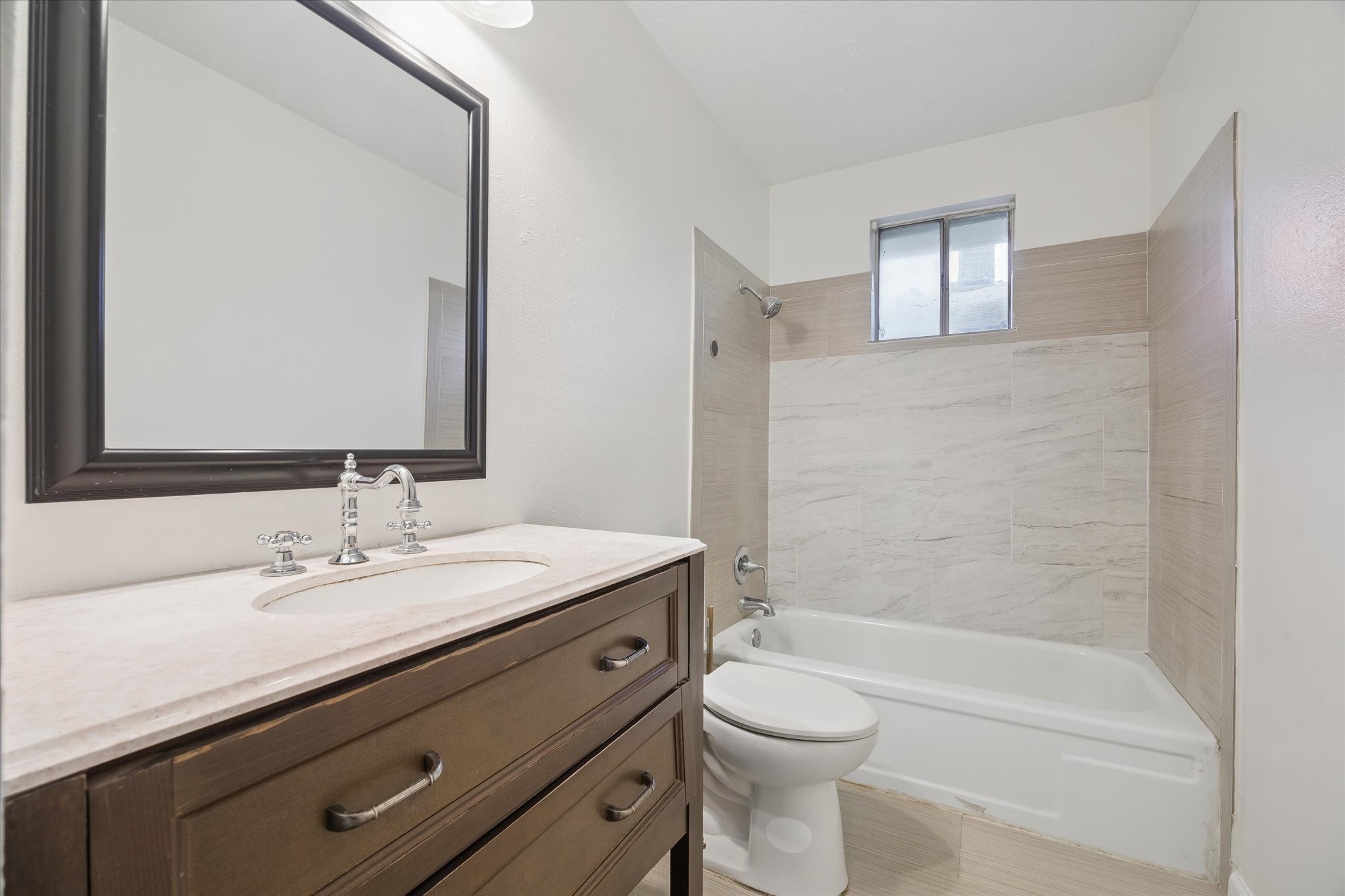 4731 Brookston Street Houston, TX 77045 - Photo 11 of 13 a bathroom with a granite countertop sink a toilet and shower