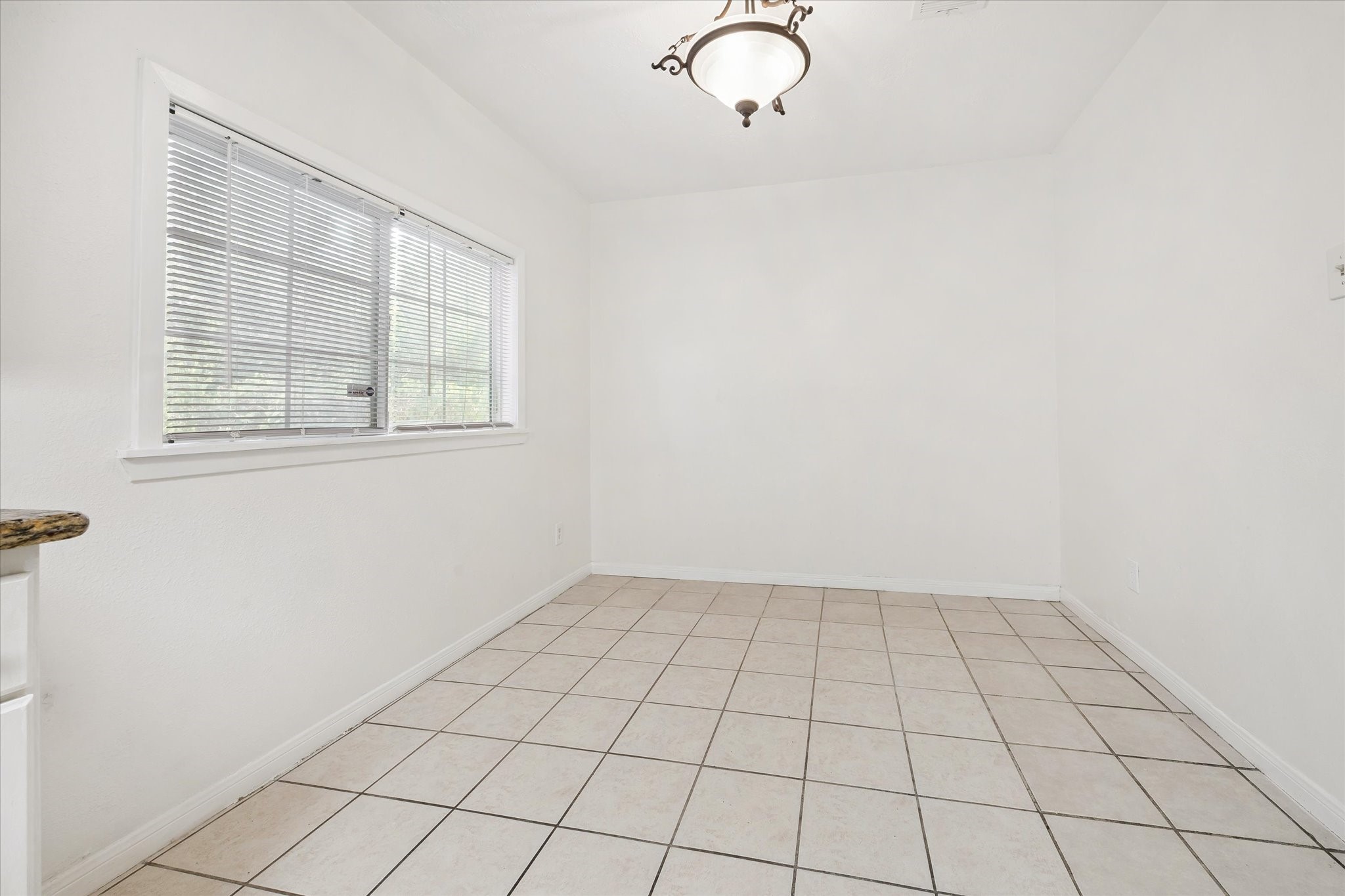 4731 Brookston Street Houston, TX 77045 - Photo 6 of 13 an empty room with windows