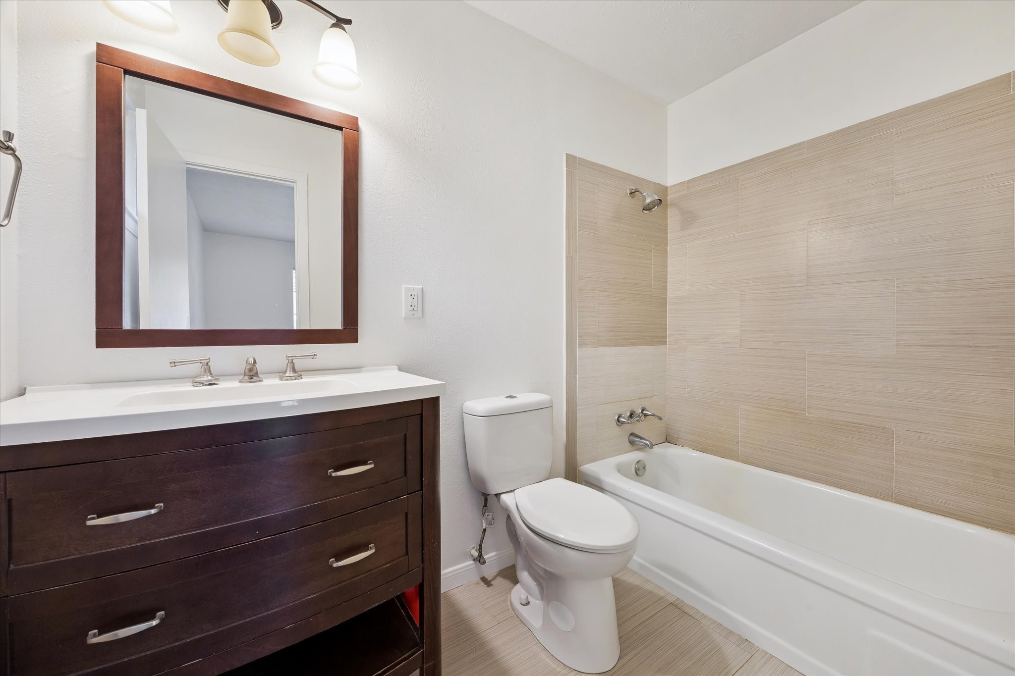4731 Brookston Street Houston, TX 77045 - Photo 8 of 13 a bathroom with a toilet sink and mirror