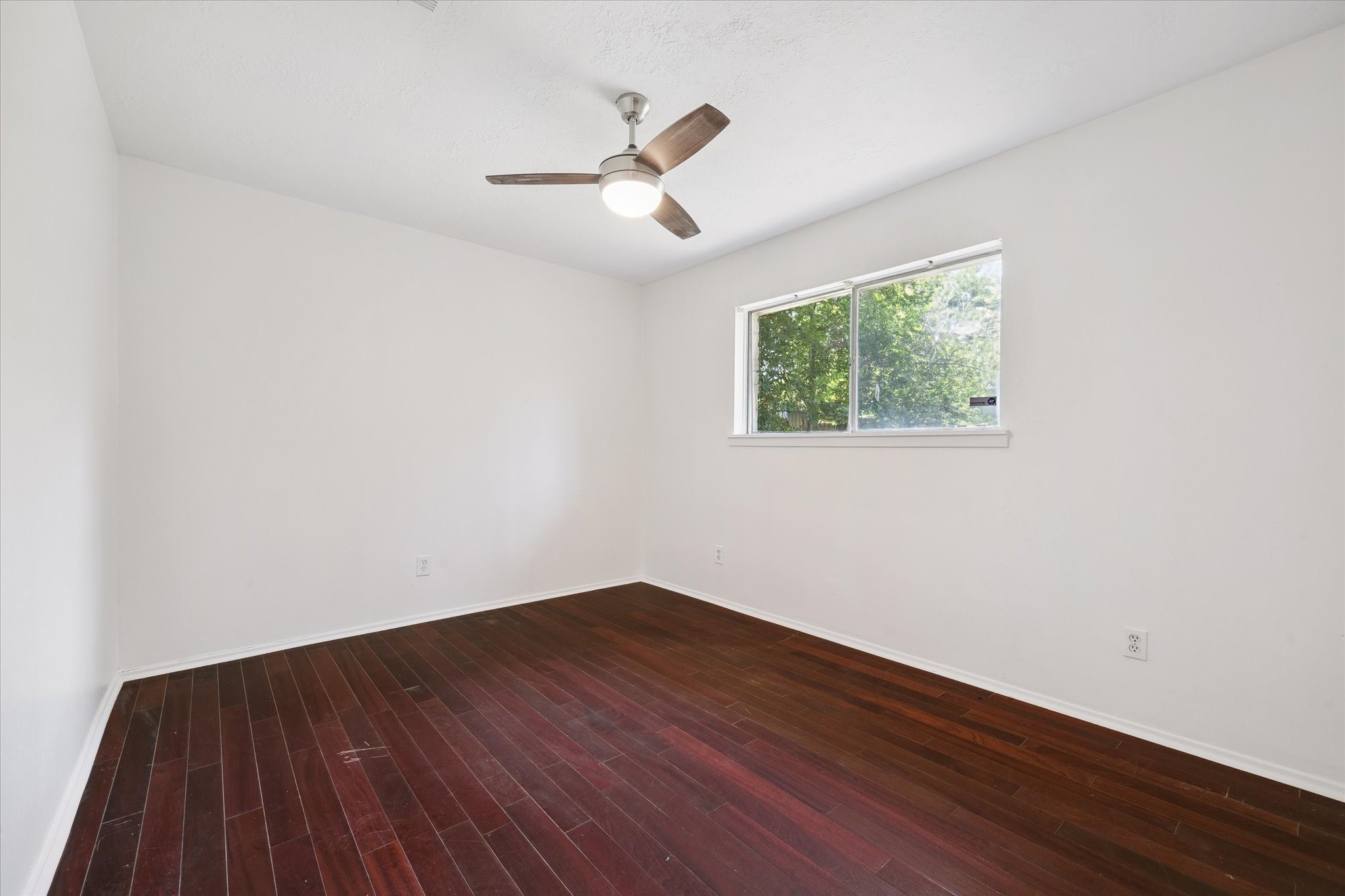 4731 Brookston Street Houston, TX 77045 - Photo 10 of 13 a view of empty room with wooden floor and fan