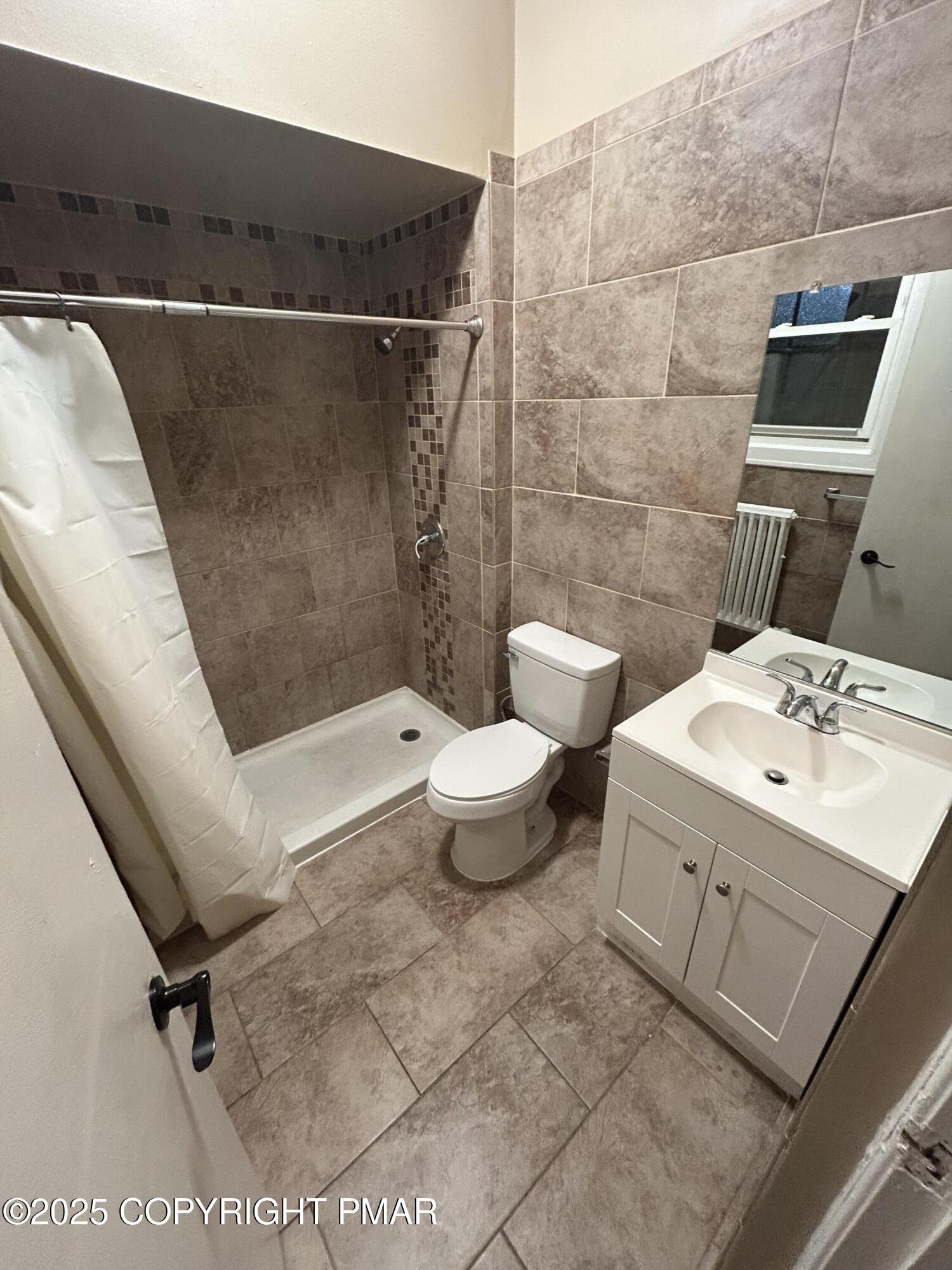 296 Washington Street, Unit 3B East Stroudsburg, PA 18301 - Photo 5 of 5 a bathroom with a sink and toilet