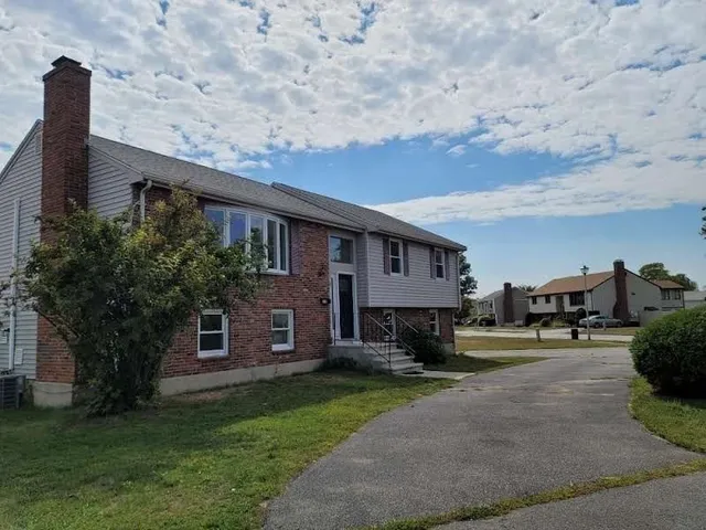 a view of a house with a yard and tree s