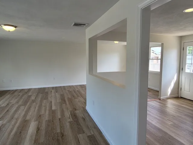 wooden floor in a empty room with a window