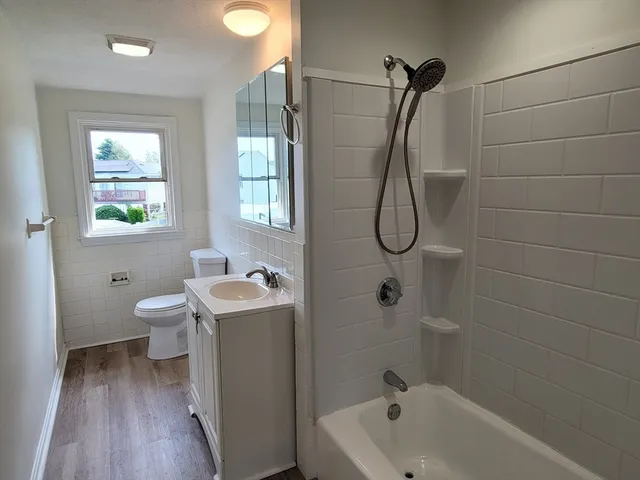 a bathroom with a granite countertop toilet a sink and bathtub