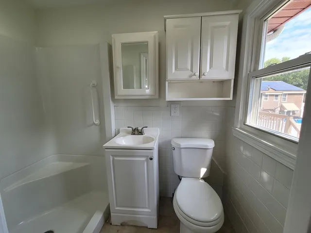 a white toilet sitting next to a bathroom sink