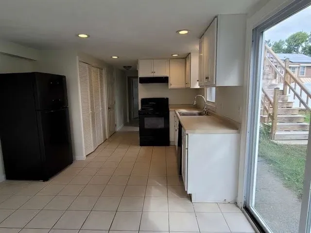 a kitchen with a refrigerator and a stove top oven