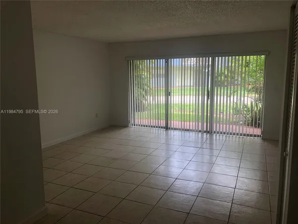 a view of an empty room and a window