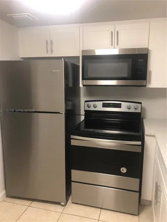 a stove top oven sitting inside of a kitchen