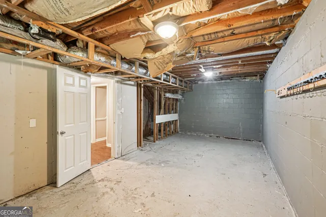 a view of empty room with wooden walls