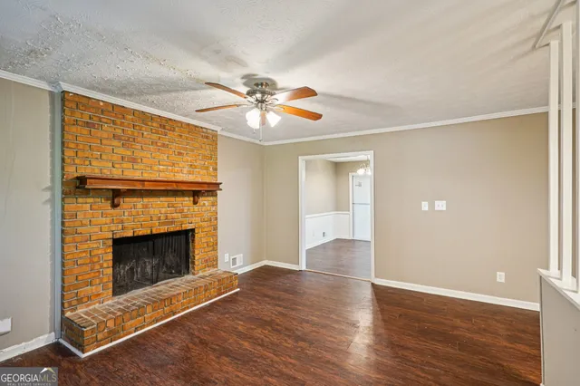 wooden floor fireplace and windows in an empty room