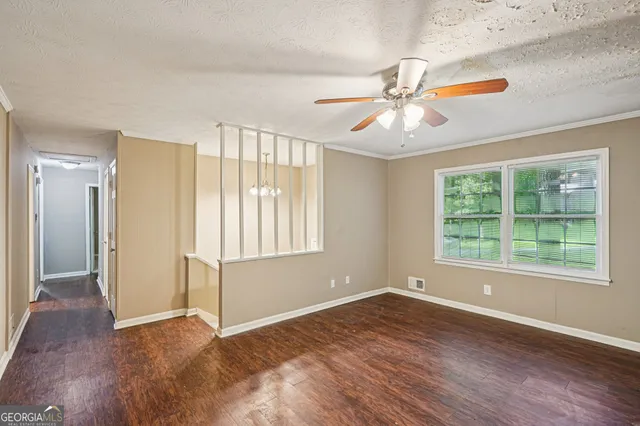 wooden floor in an empty room with a window