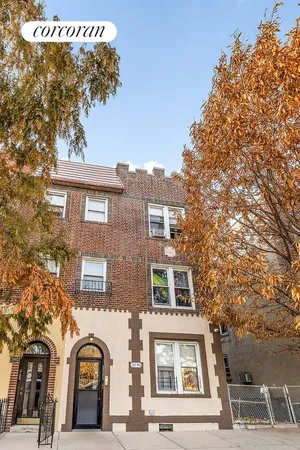 a front view of a residential apartment building with a yard