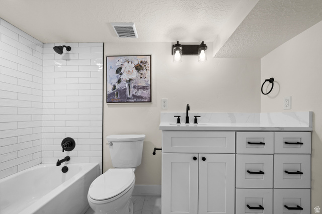 189 West Center Street Midvale, UT 84047 - Photo 35 of 64 Full bathroom featuring a white subway tile tub surround, matte black fixtures, a white vanity with a stone-finish countertop, and a contemporary wall-mounted light fixture