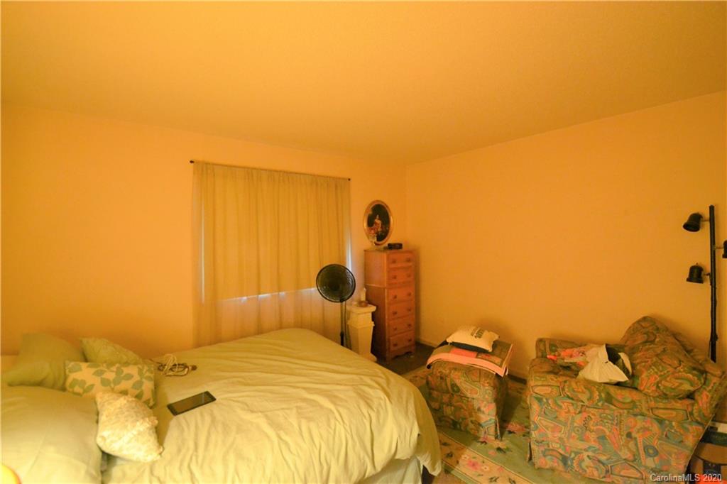 2343 Roland Drive, Unit C Monroe, NC 28110 - Photo 11 of 15 a bed sitting in a bedroom next to a bathroom