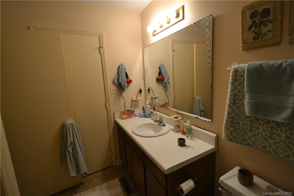 2343 Roland Drive, Unit C Monroe, NC 28110 - Photo 12 of 15 a bathroom with a sink a mirror and a shower