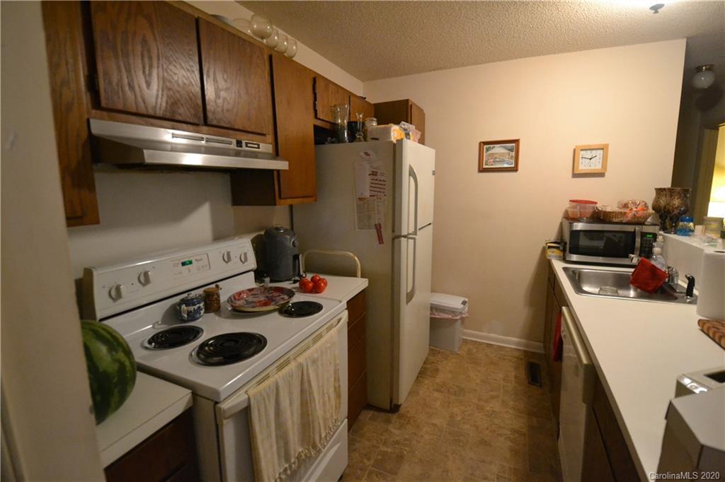 2343 Roland Drive, Unit C Monroe, NC 28110 - Photo 3 of 15 a kitchen with stainless steel appliances a stove a sink and a refrigerator