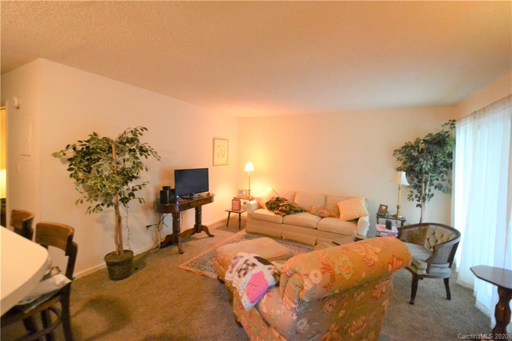 2343 Roland Drive, Unit C Monroe, NC 28110 - Photo 6 of 15 a group of blue chairs sitting in a living room with a balcony