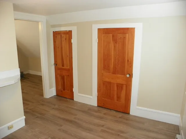 an empty room with wooden floor