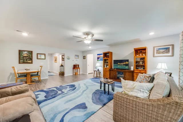 a kitchen with stainless steel appliances granite countertop grey cabinets a stove a sink and a microwave