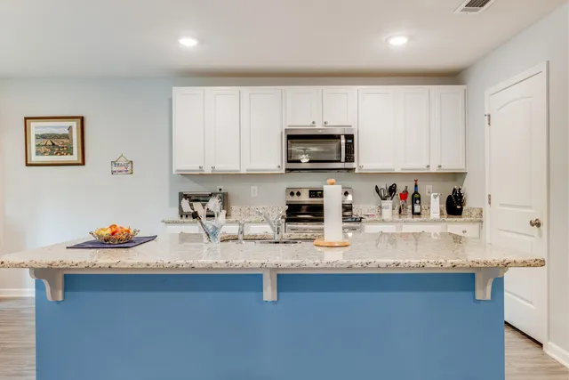 a kitchen with sink a stove and cabinets