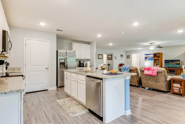 a kitchen with granite countertop cabinets a sink and dishwasher stove
