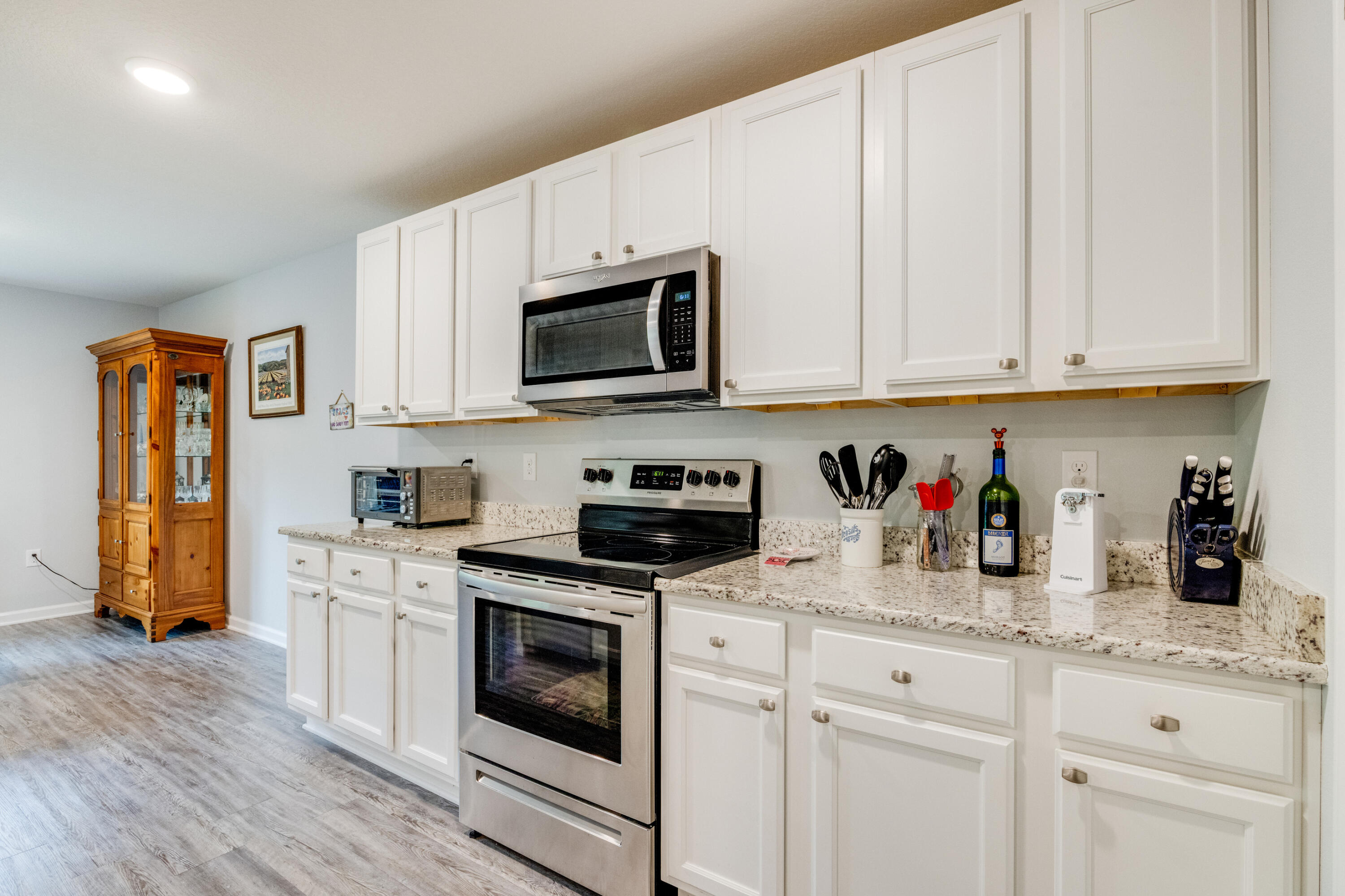 340 Merlin Court Crestview, FL 32539 - Photo 24 of 63 a kitchen with granite countertop white cabinets and stainless steel appliances