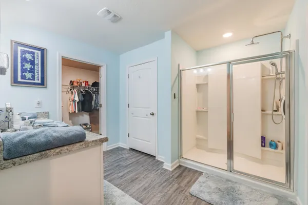 a bathroom with a granite countertop sink mirror toilet and bathtub