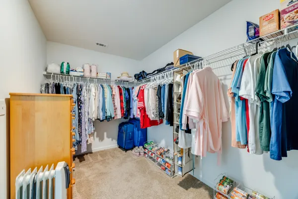 a view of a hallway with wooden floor and closet