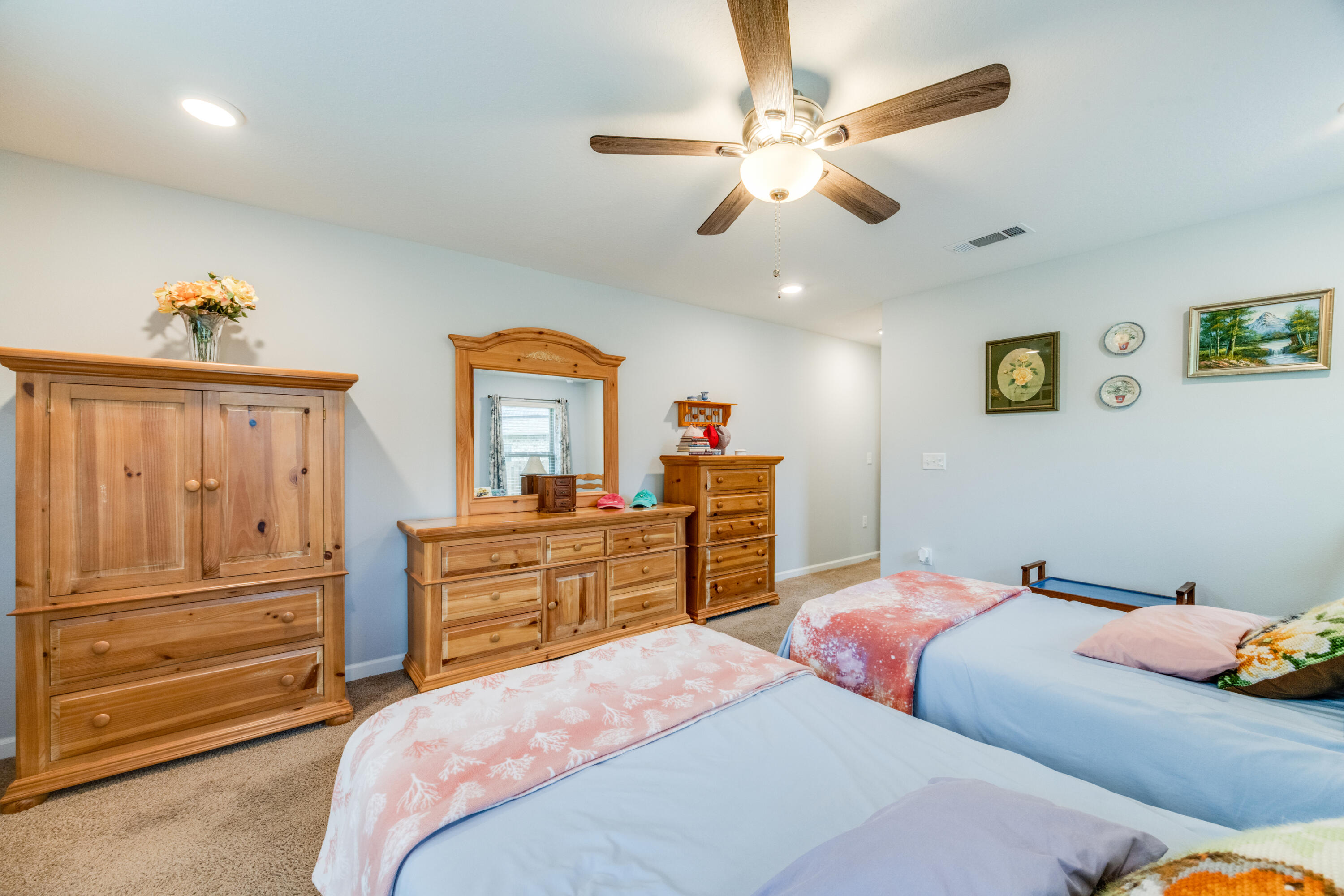340 Merlin Court Crestview, FL 32539 - Photo 28 of 63 a bedroom with a bed and wooden floor