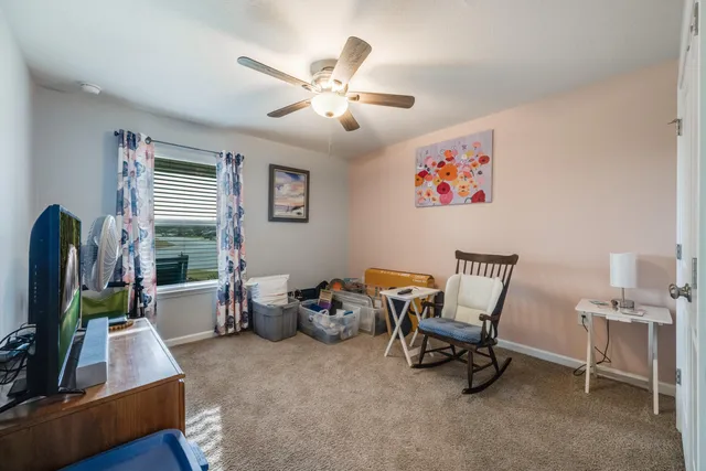 a view of a hallway with closet and a livingroom view