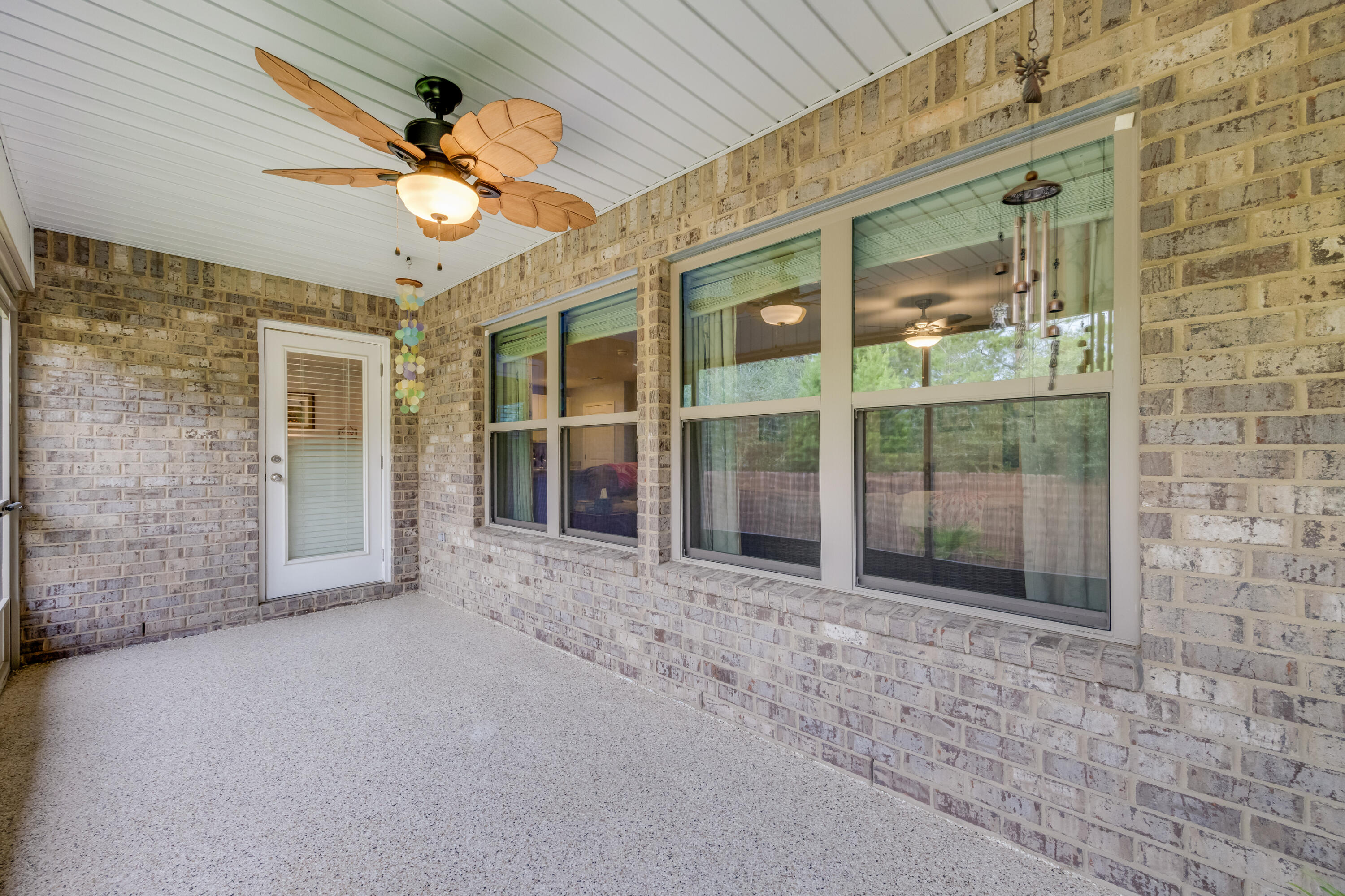 340 Merlin Court Crestview, FL 32539 - Photo 44 of 63 a view of a porch with a table and chairs