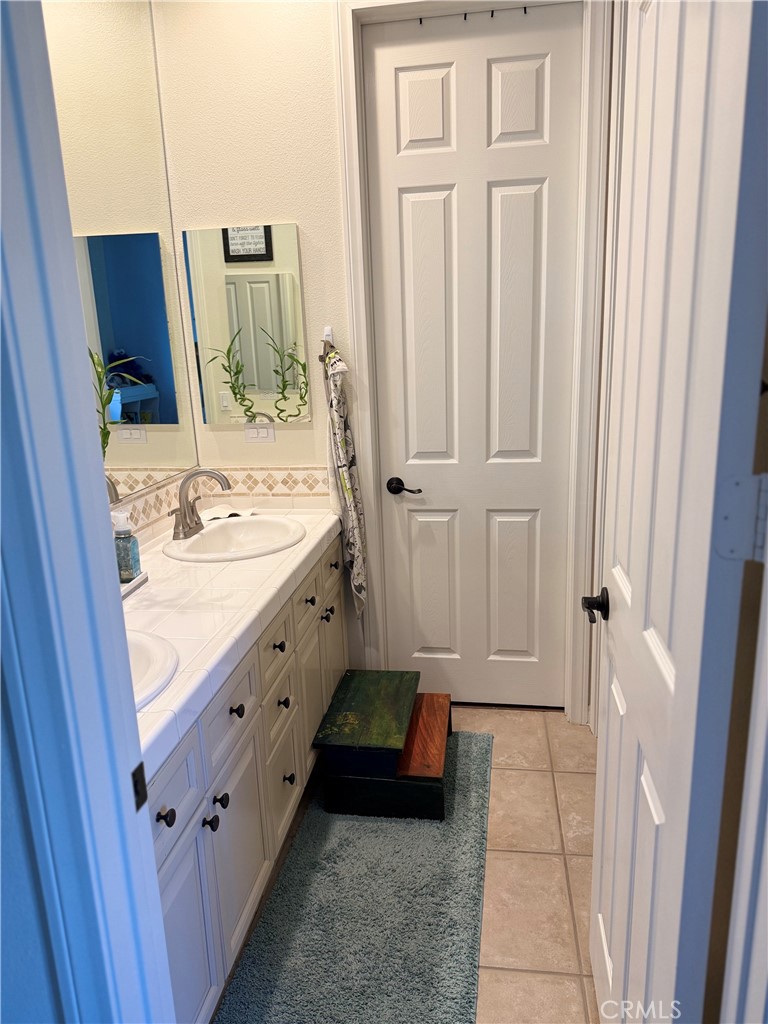 244 Via Padua Rancho Mirage, CA 92270 - Photo 15 of 35 a bathroom with a sink a mirror and a vanity