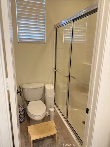 a bathroom with a toilet and a shower