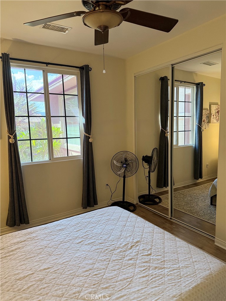 244 Via Padua Rancho Mirage, CA 92270 - Photo 23 of 35 a bedroom with a bed and wooden floor