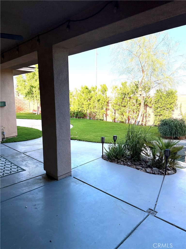 244 Via Padua Rancho Mirage, CA 92270 - Photo 26 of 35 a view of a porch with furniture and a yard
